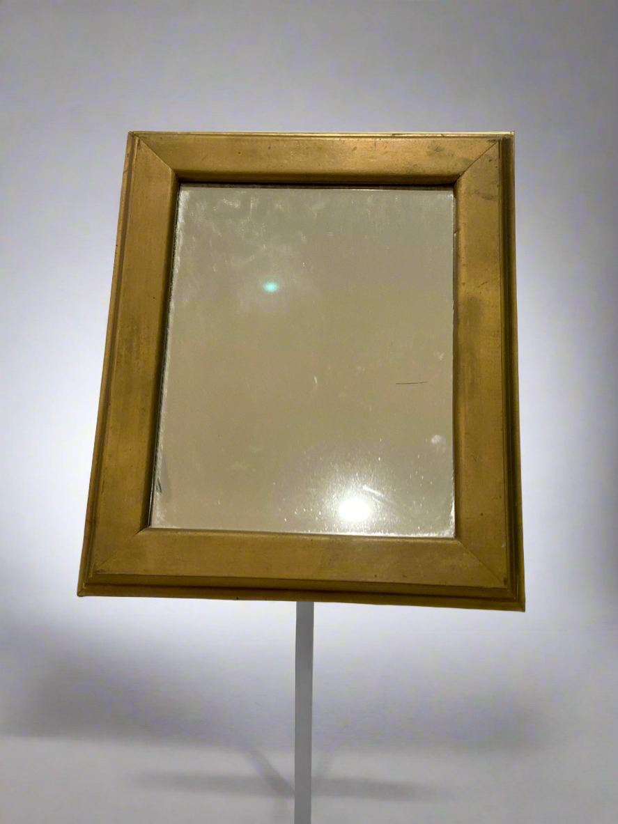 Gold colored wooden frame mirror
