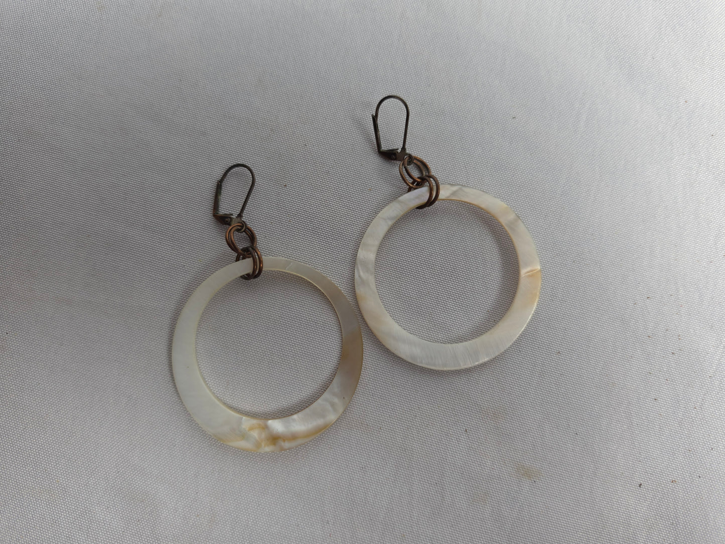 NATURAL shell donut suspended by brass earrings CSHW