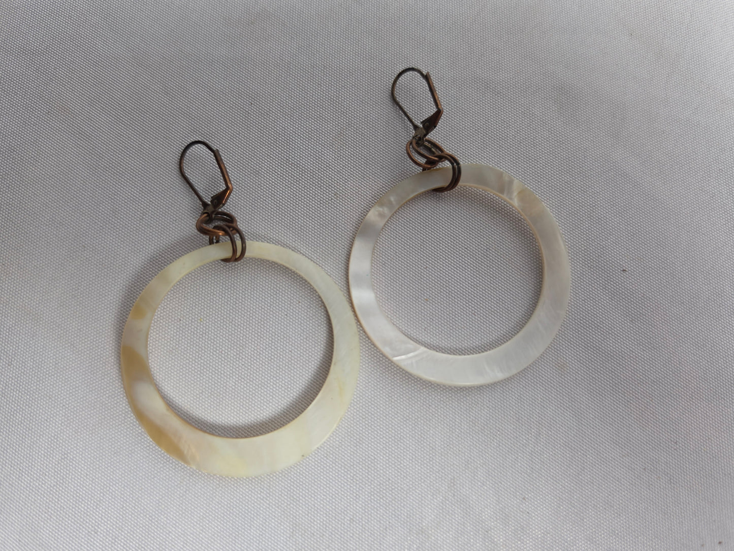 NATURAL shell donut suspended by brass earrings CSHW