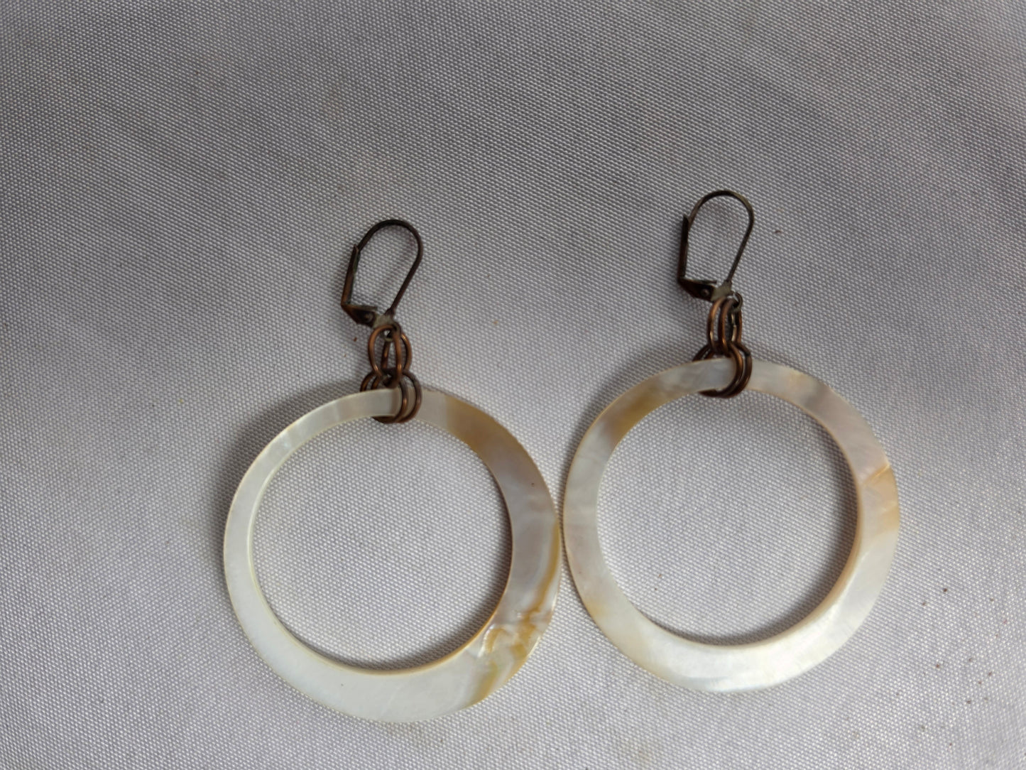 NATURAL shell donut suspended by brass earrings CSHW