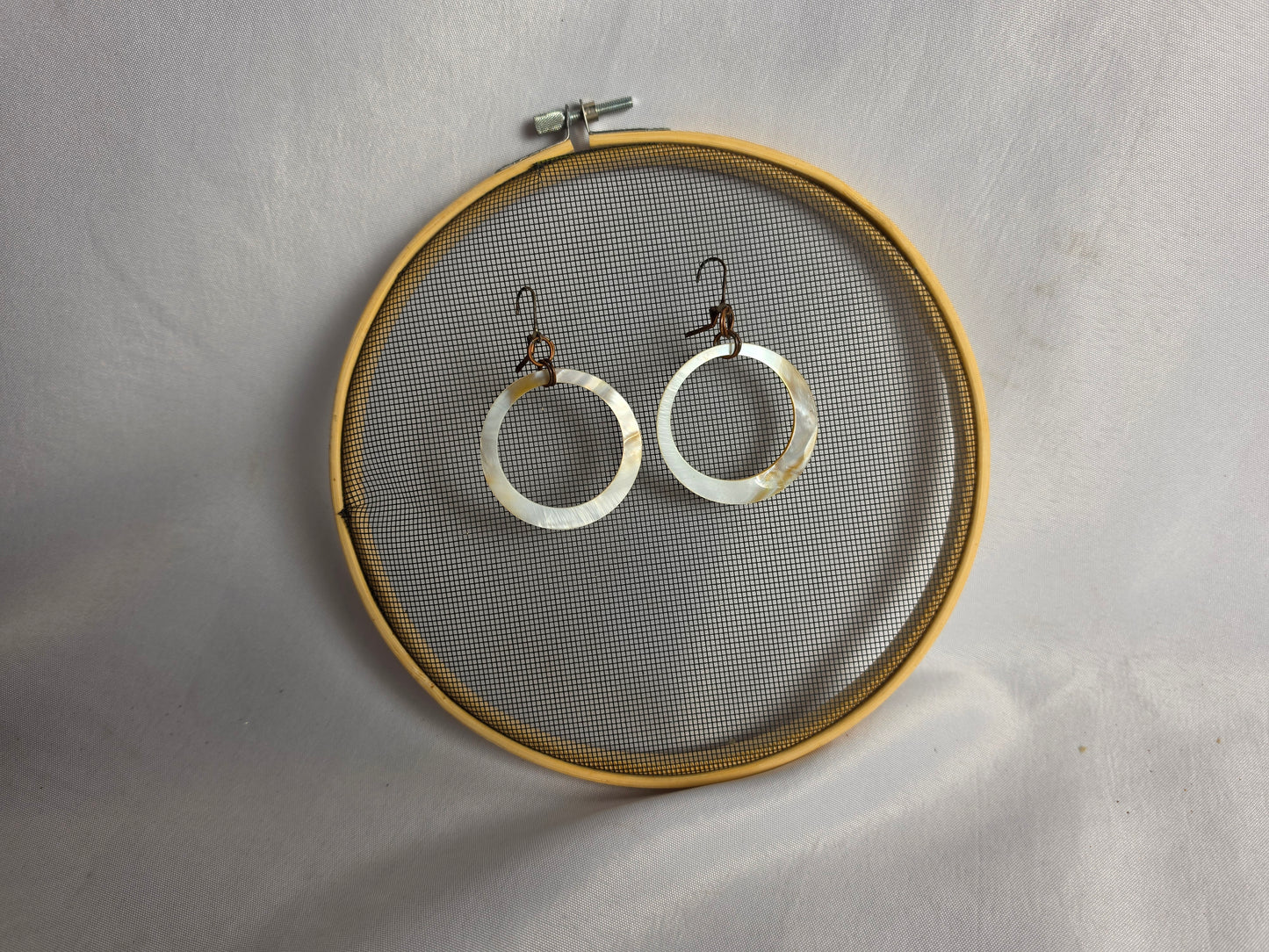NATURAL shell donut suspended by brass earrings CSHW