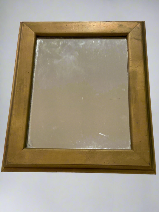 Gold colored wooden frame mirror